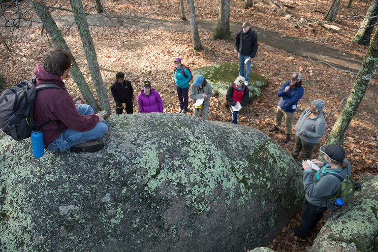 Matt Trembath, a UI geology major and U.S. Air Force veteran, peers down at his fellow geology students at Elephant Rocks State Park.