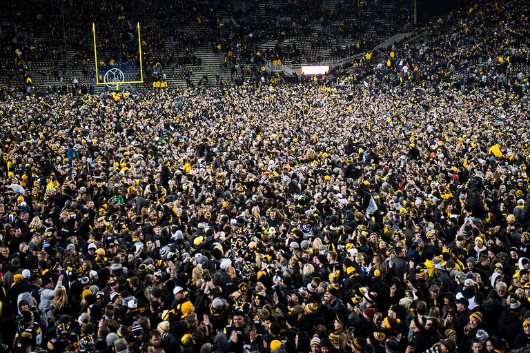 Crowd covers the field at Kinnick Stadium