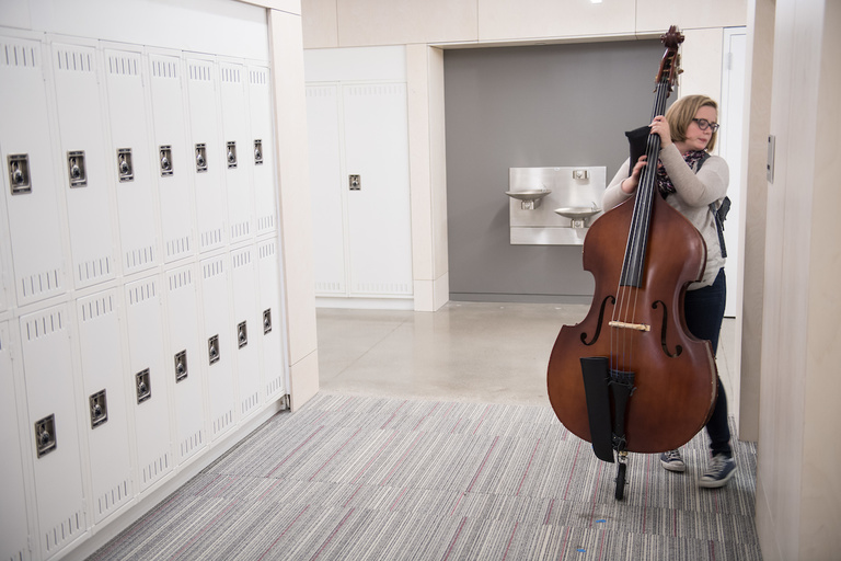 A bass student slips into a practice room.