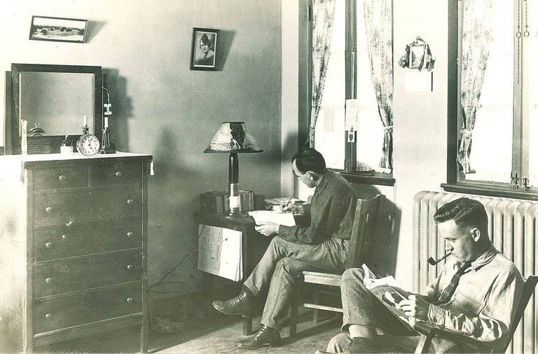 black-and-white image of men sitting in Quadrangle room