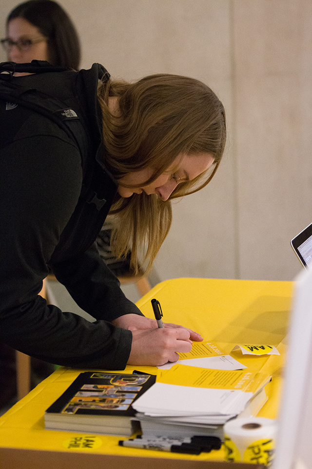 A UI student stops to sign a thank-you card for a donor in the Boyd Law Building.