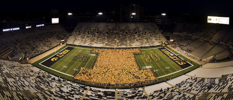 Panoramic image of students forming block I on field at Kinnick Stadium.