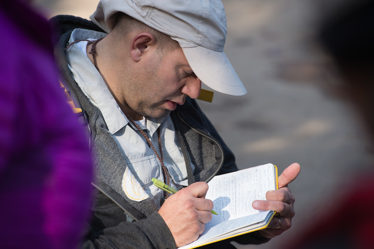 Mike Simon, a UI senior majoring in geology, takes notes in a special waterproof notebook used by geologists in the field. 