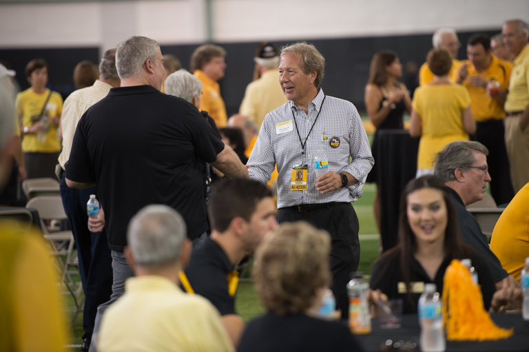 Bruce Harreld greets Hawk fans at the Presidential Tailgate on Saturday.