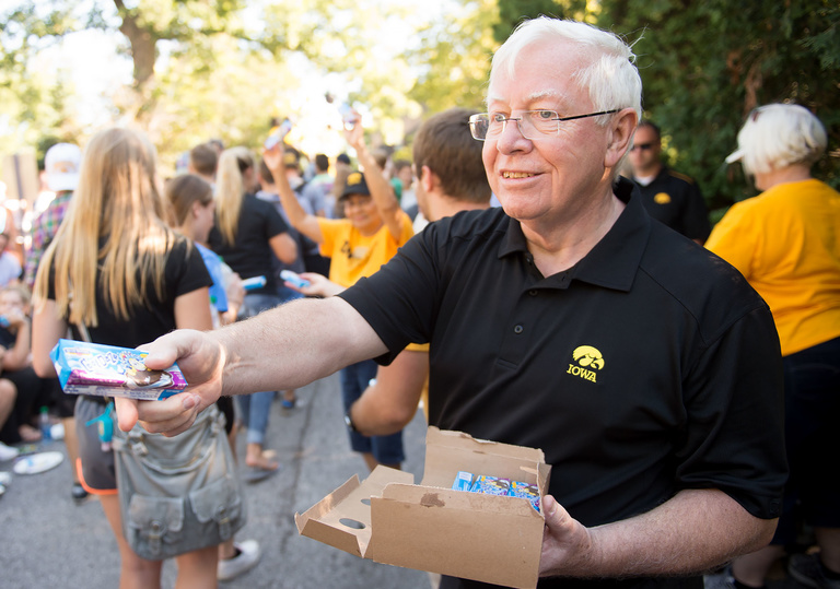Interim President Jean Robillard hands out ice cream at the annual Block Party following Convocation.