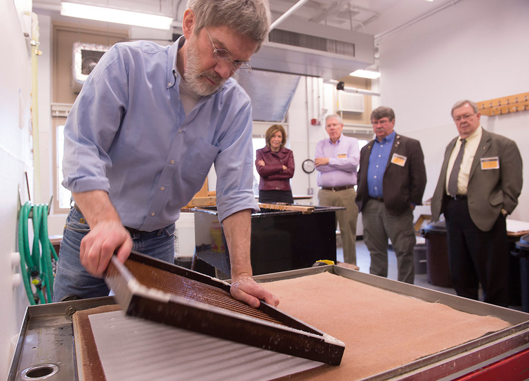 Timothy Barrett, Director of the UI Center for the Book, (foreground) demonstrates paper-making for (left to right) State Sens. Rita Hart of Wheatland and Bob Dvorsky of Coralville and state Reps. Dean Fisher of Garwin and Dave Heaton of Mount Pleasant du