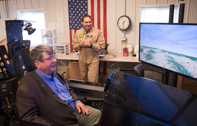 State Rep. Dean Fisher sits in the cockpit of a flight simulator at the Operator Performance Laboratory, based at the Iowa City Airport and directed by Professor Tom Schnell of the College of Engineering.
