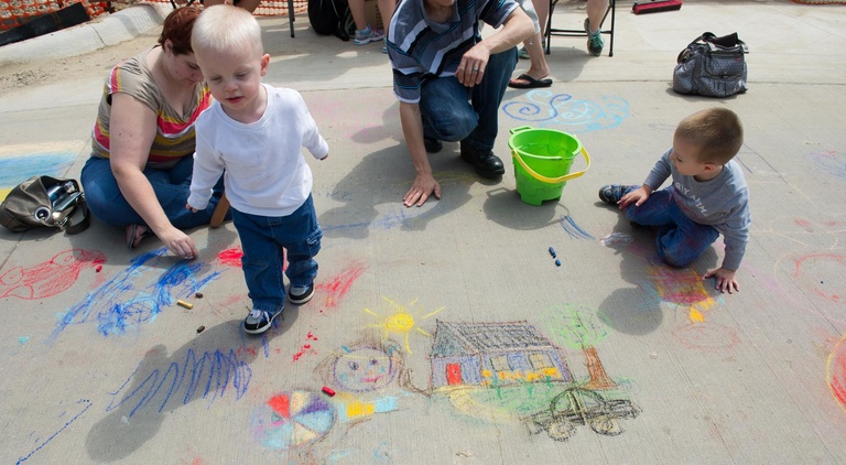 child walking through chalk art