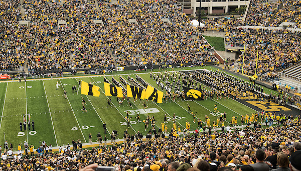 The black-and-gold I-O-W-A run out onto the field.