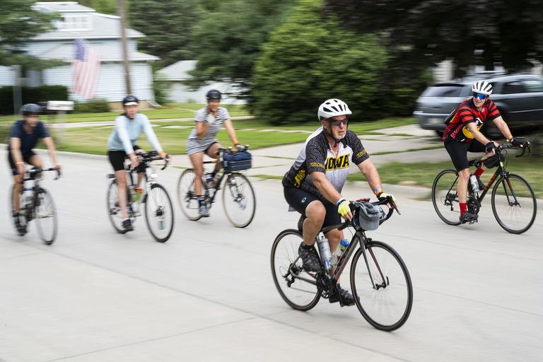 An Iowa fan rides into a pass-through town. Tuesday, July 25—when riders made their way from Ida Grove to Pocahontas—was designated college jersey day by the RAGBRAI committee.
