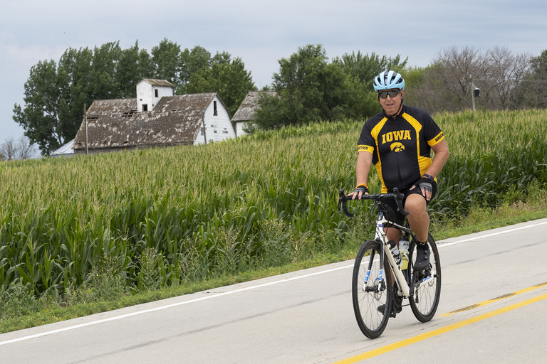 An Iowa fan makes their way along the picturesque countryside. Tuesday, July 25—when riders made their way from Ida Grove to Pocahontas—was designated college jersey day by the RAGBRAI committee.
