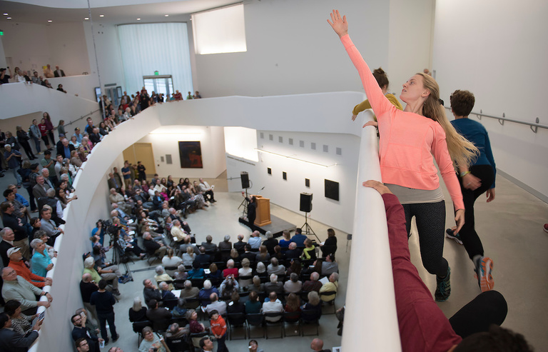 woman reaching skyward at visual arts building grand opening
