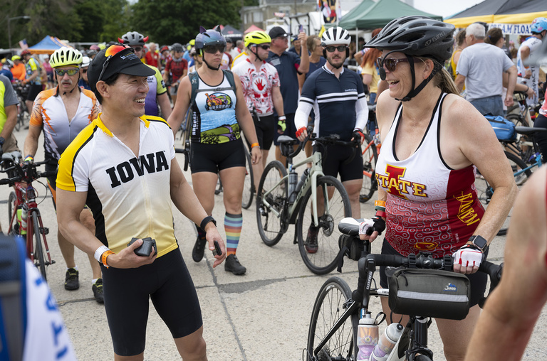 Elliott Sohn, a member of the official team representing the University of Iowa, chats with an Iowa State fan.
