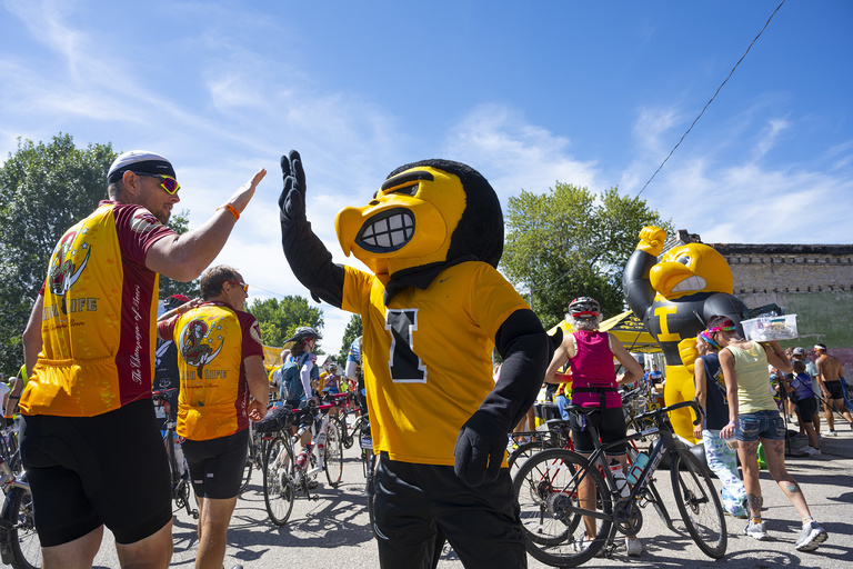 Herky high-fives a RAGBRAI rider during a stop in Marble Rock on Thursday, July 28. Riders that day pedaled 48 miles from Mason City to Charles City.