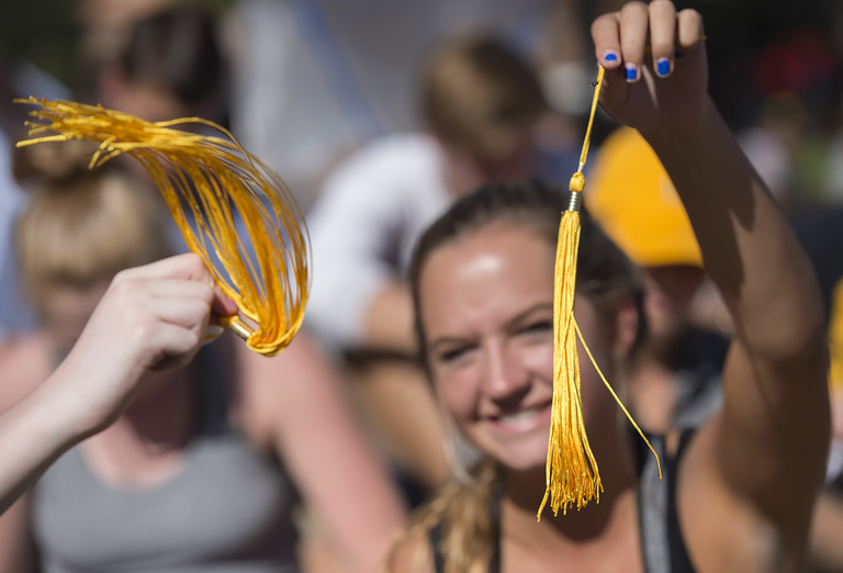 Students waves her graduation tassel at Convocation.