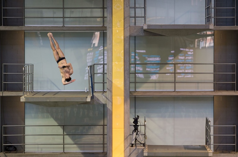 A diver flips during warm-ups.