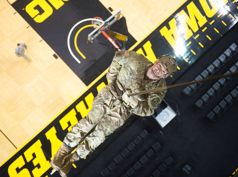 Maj. Chris Guderski rappels about 66 feet from the rafters to the court in Carver-Hawkeye Arena.