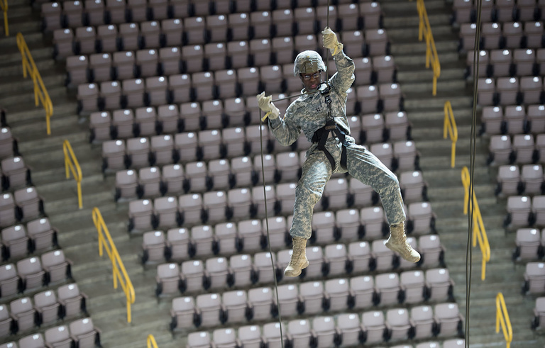 Captain Rodney Bunyan lowers himself to the court during a rappelling practice. 