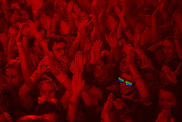 Crowd bathed in red light