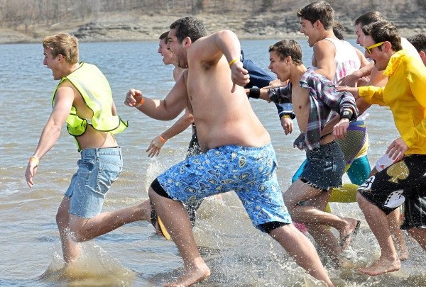 Members of Sigma Chi race into the water during last year's polar plunge.