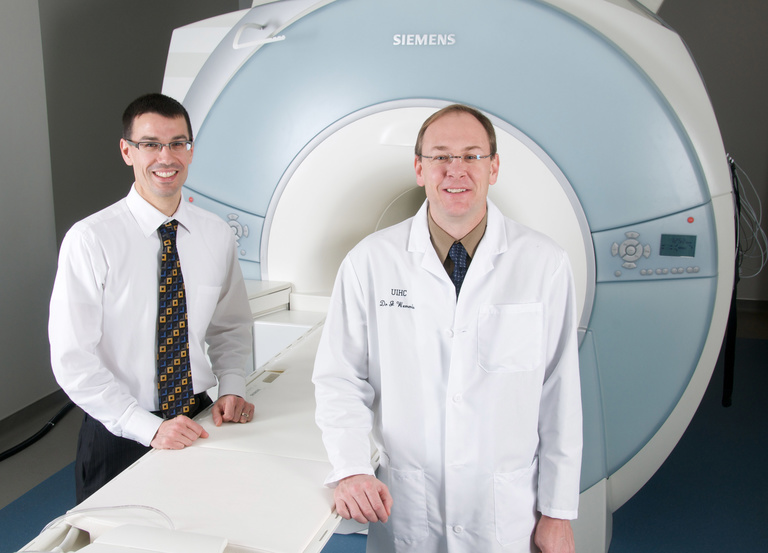 Vincent Magnotta and John Wemmie in front of MRI machine