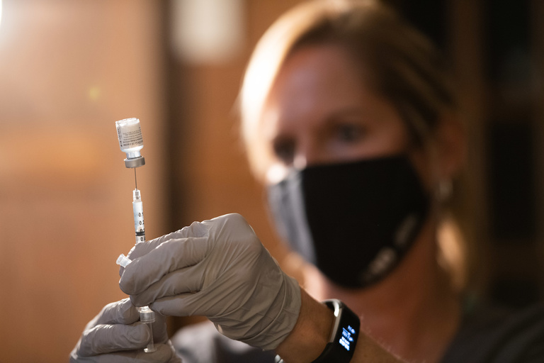 health care worker with vaccine