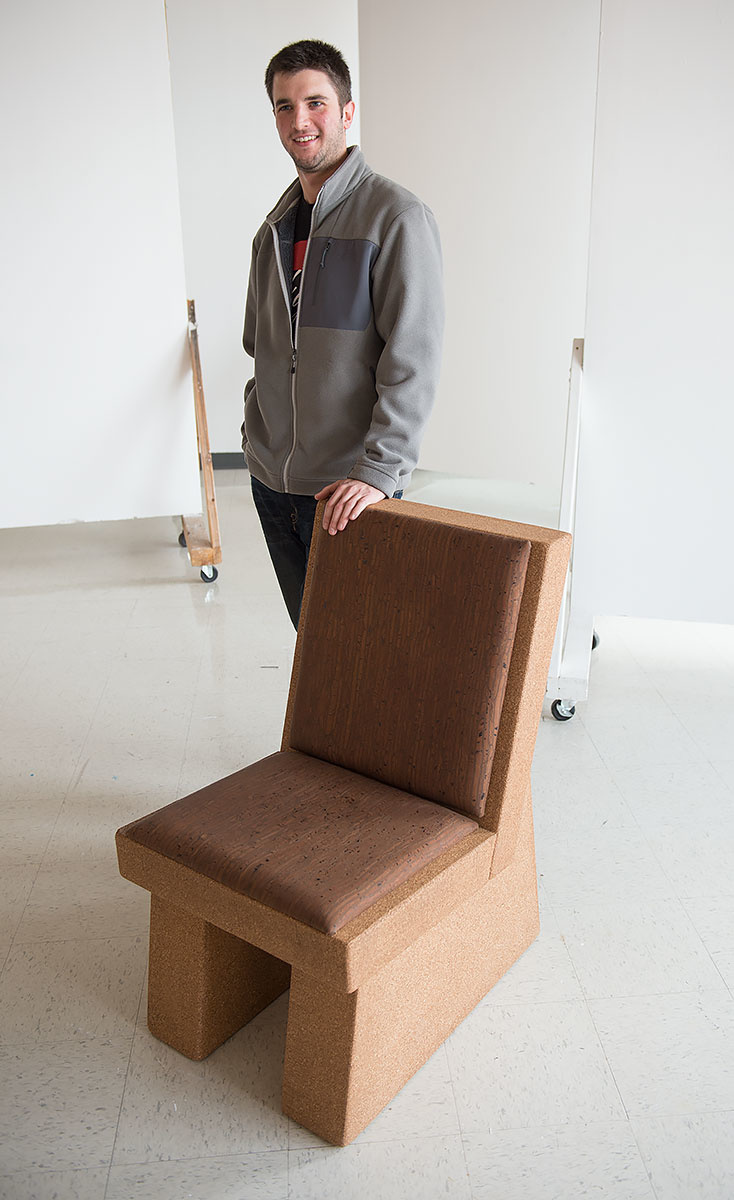 alex zeppieri standing by chair made of cork