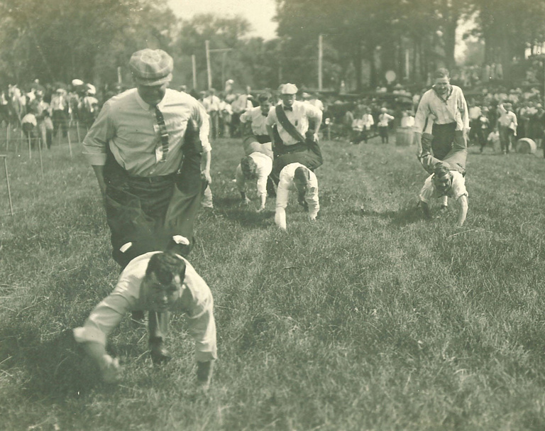Human wheelbarrow race at City Park for Senior Frolic, 1910s