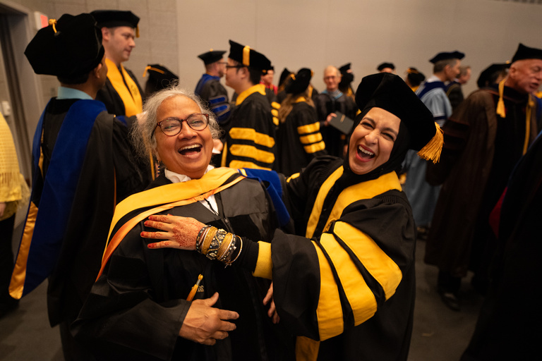 Two graduates celebrating