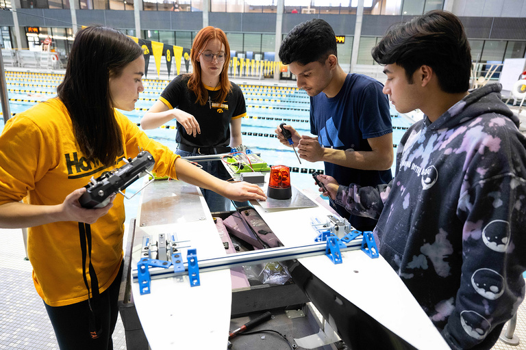 students working on a hydrofoil-assisted catamaran