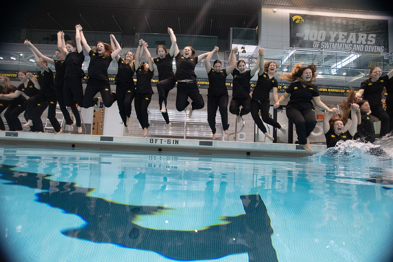 nursing graduates jumping into a pool