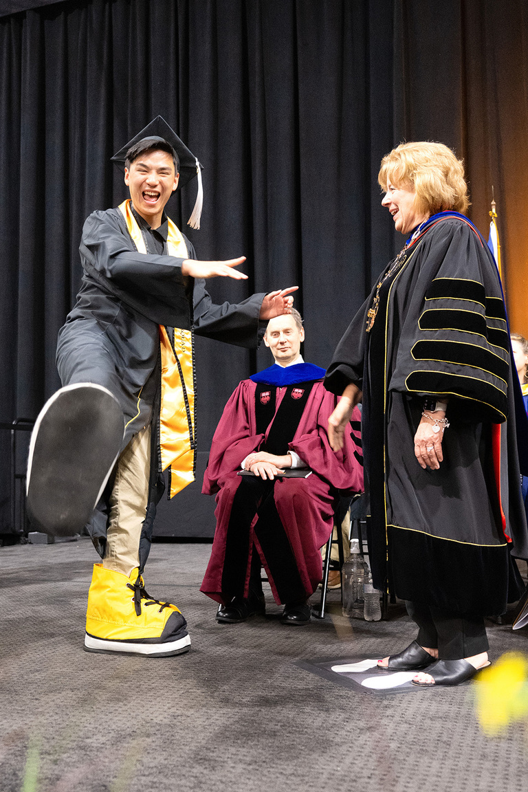 student celebrates at commencement with President Barb Wilson