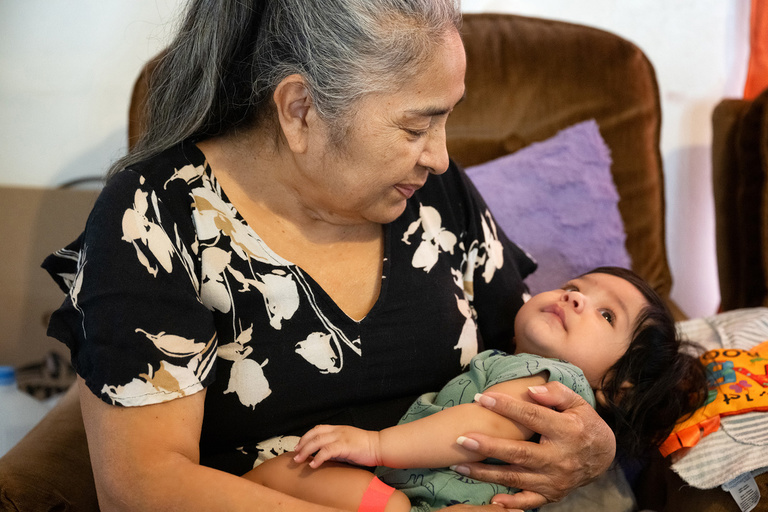 a woman holds one of her grandchildren