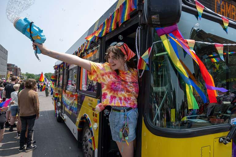 a young woman steps off a bus during the Iowa City Pride celebration