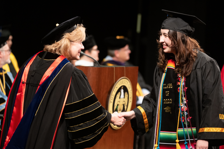 President Wilson shakes the hand of a new graduate