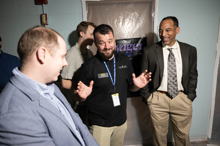 Richard Dvorsky (center), aerospace principal engineer in the Department of Physics and Astronomy, chats with NASA representatives 