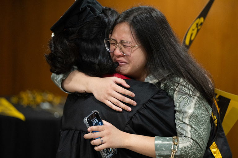 Graduate receiving a hug at spring 2024 commencement