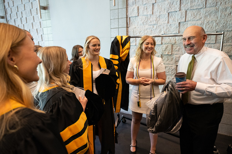 Graduates speaking with College of Pharmacy Dean Don Letendre