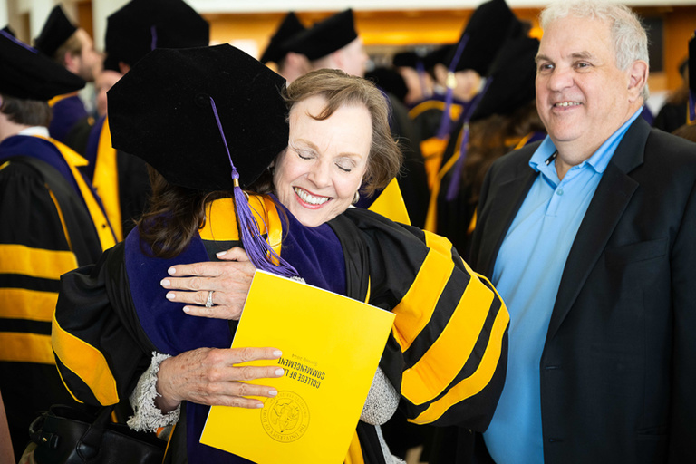 Graduate receiving a hug