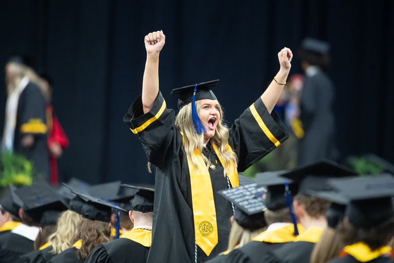 Graduate cheering at commencement