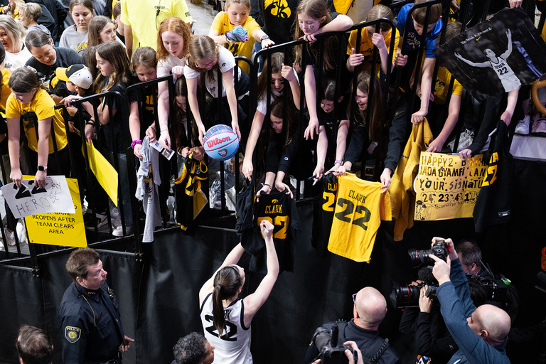 Iowa basketball player Caitlin Clark signs autographs for fans at Carver-Hawkeye Arena