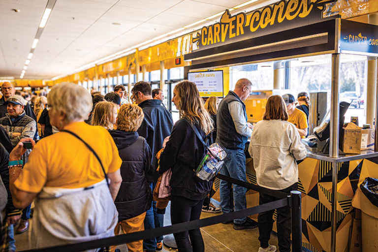 A large group of people at Carver Hawkeye Arena standing in line for a Carver Cone ice cream cone