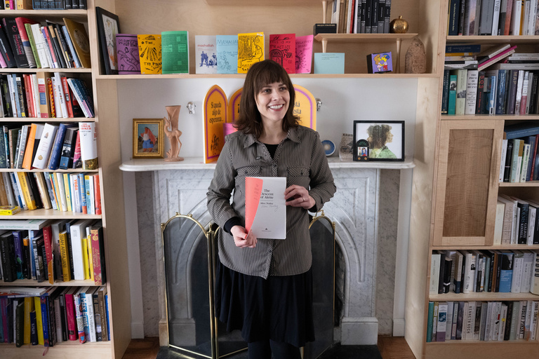 UI professor and author Paige Lewis holds a copy of "The Descent of Alette"