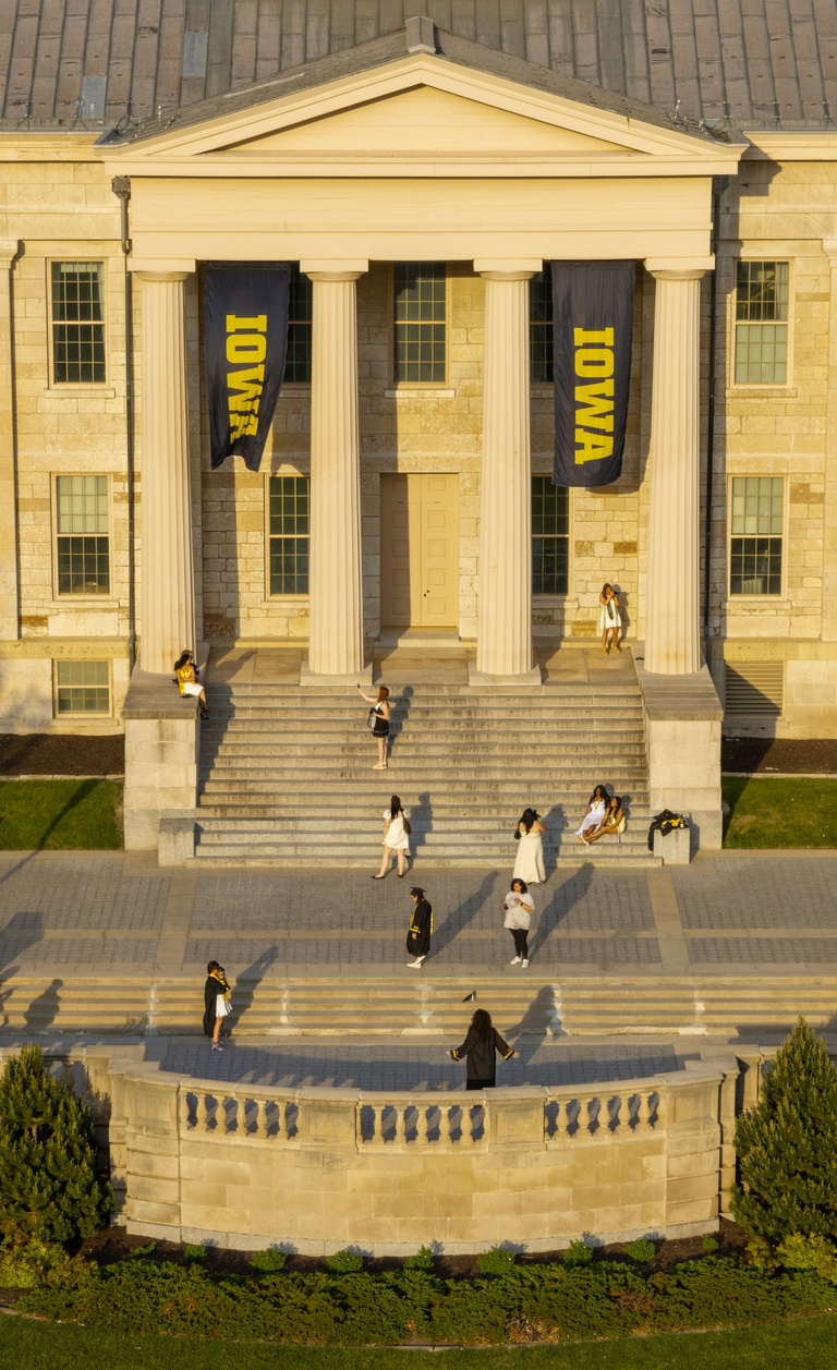 A drone image of graduates taking photos in front of Old Capitol
