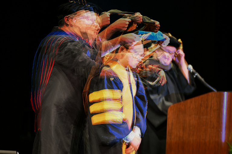 A graduate receives their hood 