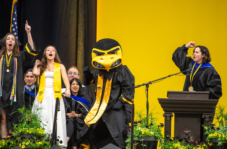 Members of the Spirit Squad who were the mascot Herky do a cheer