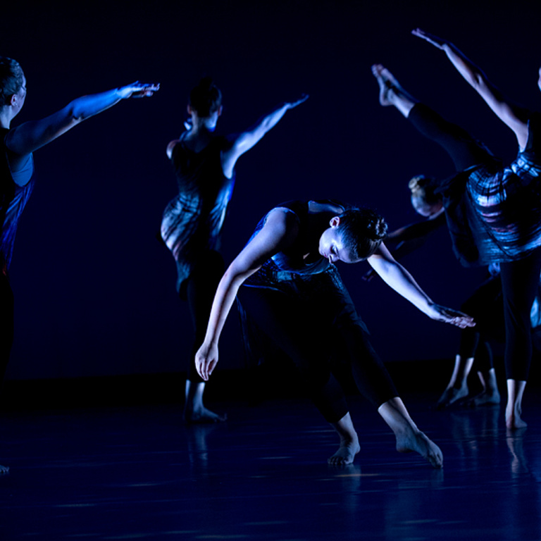 dancers perform on stage