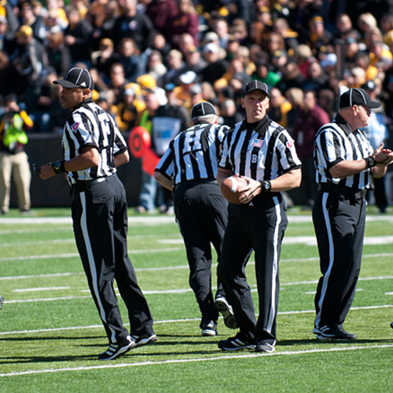 Officials split up for the kickoff.