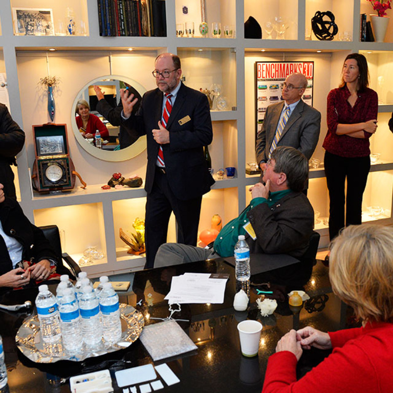 UI Vice President for Research and Economic Development Dan Reed (center, gesturing) talks during a visit to M.C. Ginsberg Objects of Art.