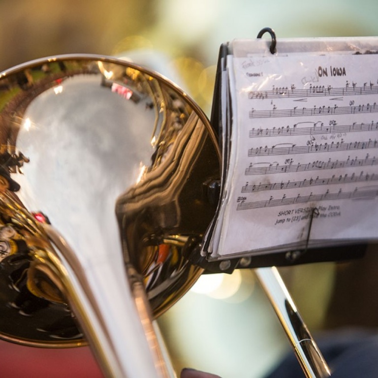 A trombone horn and a music stand.